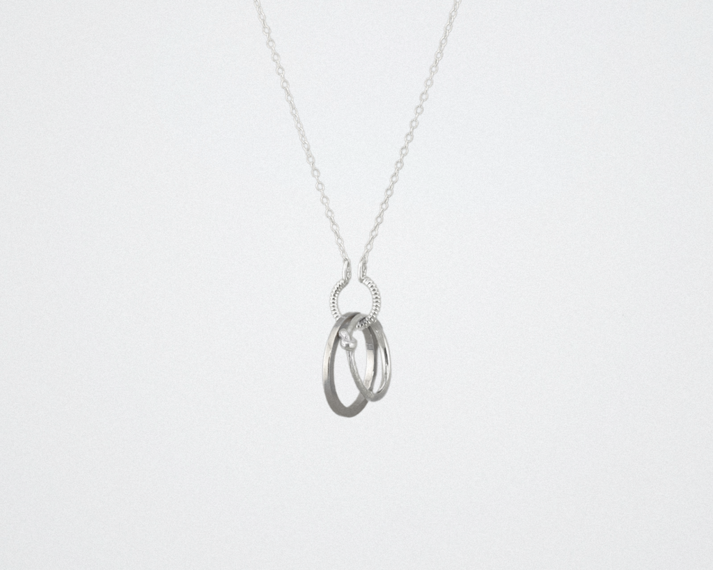 silver circle charm holding rings