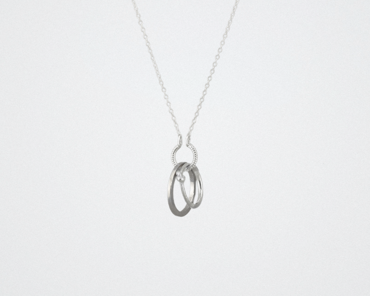 silver circle charm holding rings